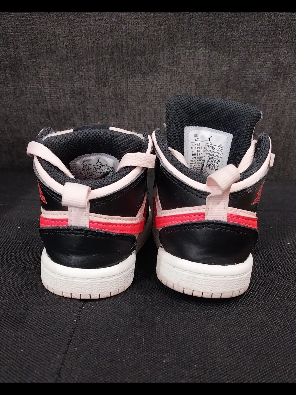 Nike Air Jordan 1 Pink and Mid Sneakers with Red Accent